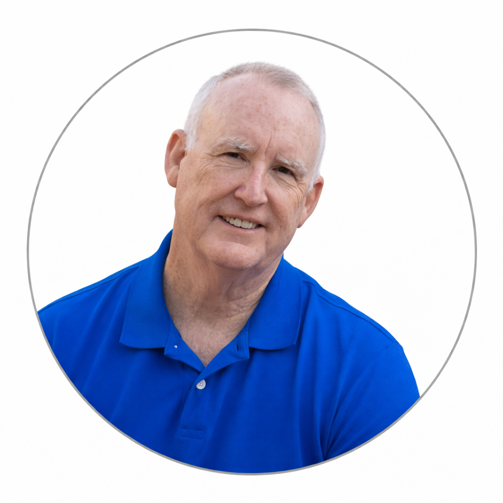 A white man in a royal blue shirt against a white background